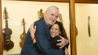 John Cleese embraces a fan.
