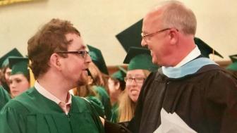Daniel Dubinsky and Jim Wilbur in academic regalia at Threshold graduation