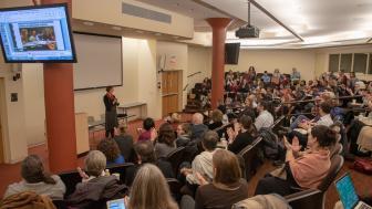 Wide audience shot, people clapping
