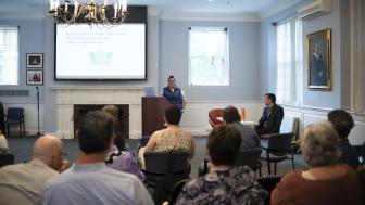 Ameilia Teta presenting project in front of audience at Alumni Hall