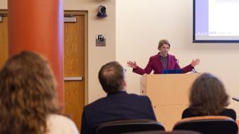 Lindsay Jones speaking at podium in University Hall Amphitheater