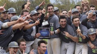 The baseball players celebrate their NECC win with their trophy.