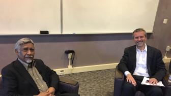 Mac Maharaj seated in Sherrill Library with moderator Roger Berry