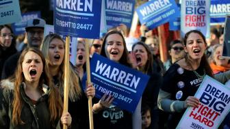 A group of women holding Elizabeth Warren signs at a rally