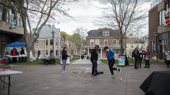 Students outside on the quad playing games at the Quadfest carnival