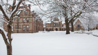 Winter scene on Lesley's western campus with 2 students in the background