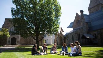 Students in an arc, chatting on Lesley's lawn.