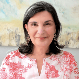Headshot photograph of Yasemin Isler smiling at the viewer. 
