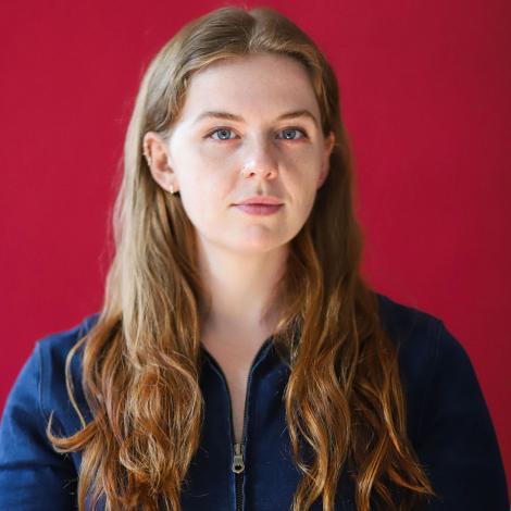 headshot of sarah jenkins in front of red wall