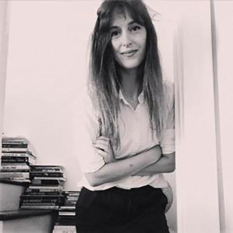 Leah Hayes Standing with Arms crossed in stairwell