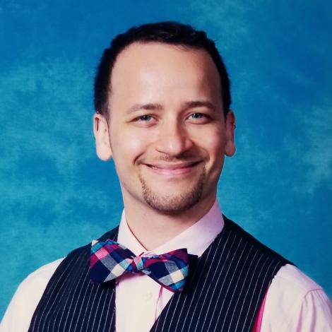 Headshot of Kit Golan in vest and bowtie