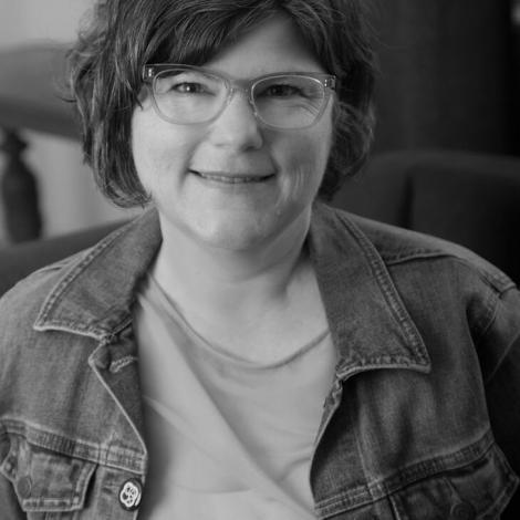 Black and white photograph of Sara Zarr smiling facing the camera.