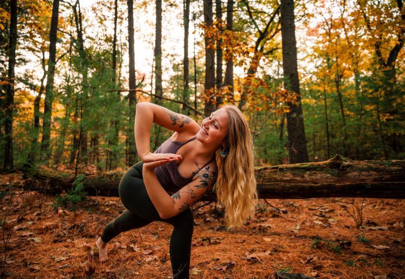 Yoga therapist Sophie Lyons '21 does yoga in the woods.