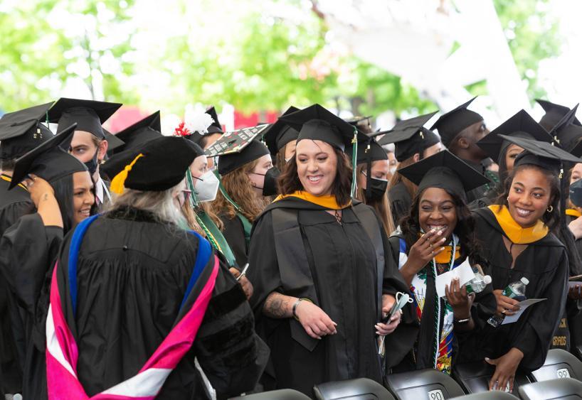 Graduates smile during Commencement