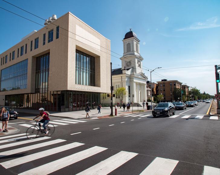 photo of lunder arts center and church along a busy inresection under a clear blue sky