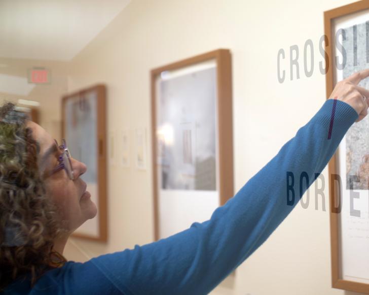 vivian poey pointing at a photograph