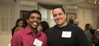 Lesly Precil in a red shirt and Michael Rivera in a black shirt pose and smile together.