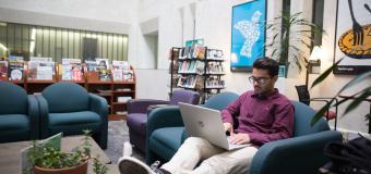 Lesley student studying in Sherill Library.