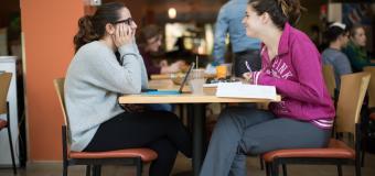 Two students talking in cafe