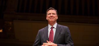 James Comey standing on the Symphony Hall stage