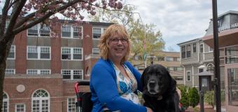 Dee Genetti and her service black lab service dog