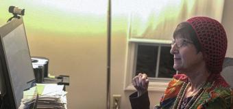 Donna Halper sitting in her office in front of a computer