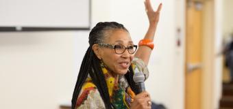 Rev. Gloria White-Hammond speaks. holding her left hand up.