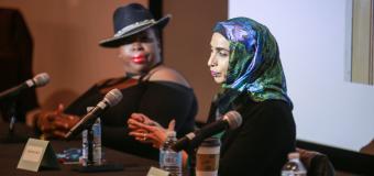 Artists Ambreen Butt speaks on a panel, while artist Nona Faustine listens