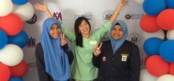 Lauren Chow with two female students in a halo of balloons