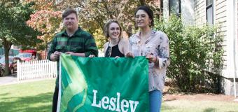Students Michael Coleman, Raine Ferrin and Christine Lopez Corado hold the new Lesley flag that they designed.