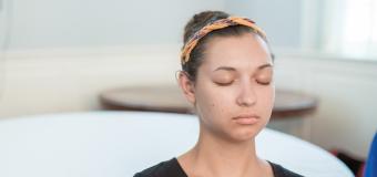 Young woman meditating with eyes closed