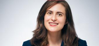 Rebecca Rolland headshot - woman with long brunette hair, red shirt under a professional jacket