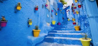 An alley in Chefchaouen, the blue city in Morocco, steps and walls painted bright blue
