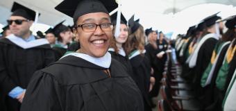 Tamara Adams smiles for the camera in her Commencement regalia