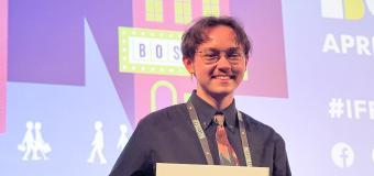 Thomas Tague-Bleau holding a certificate at film festival.