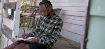 Trevonne Deveaux sits on porch and draws your vote matters design for H&M