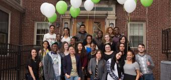 The USI students as freshmen standing outside Alumni Hall with green and white balloons.