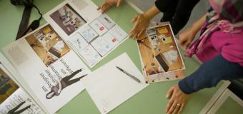 students look over print design layouts