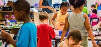 a group of children work on art projects in a classroom