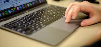 hand on laptop computer
