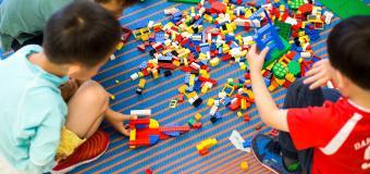 three boys playing with legos