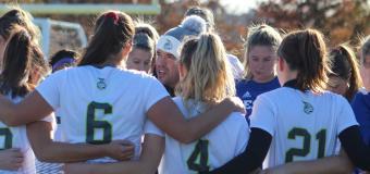Coach Paul Vasconcelos amid player huddle