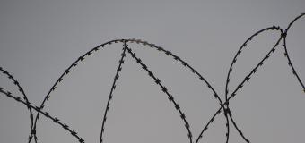 Barbed wire at the top of a fence