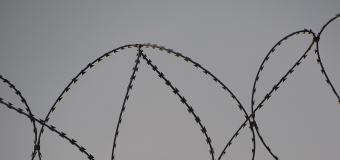 Barbed wire at the top of a fence
