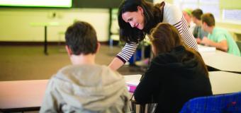 classroom teacher with students at table