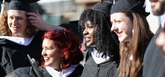 A group of happy graduates poses for a photo