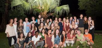 Group shot at night of the students and faculty.