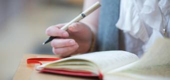 closeup of woman writing in notebook