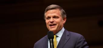 Douglas Brinkley holding a mic