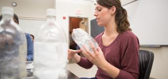 Lesley students at lab table with water bottles